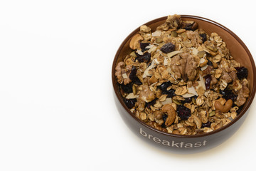 Breakfast: Bowl of whole grain muesli isolated on white background