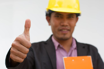 Asian engineer thumb up isolated on white background