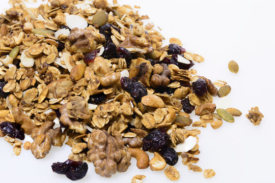 Crunchy granola or muesli scattered, isolated on white, top view.