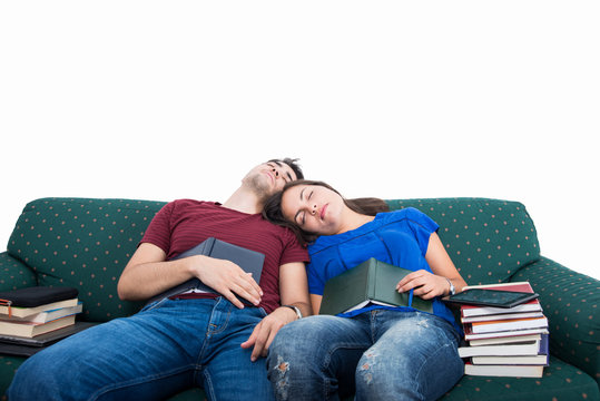 Student Couple Sleeping On Couch While Studying