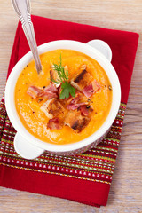 Butternut Squash and Bacon Soup in White Bowl. View from above, top studio shot, vertical