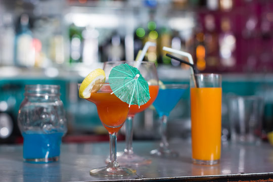 Image of various colorful cocktails on the bar counter