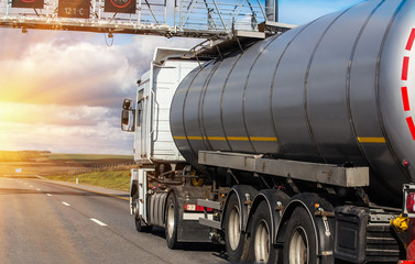 Obraz na płótnie Canvas Gas-tank goes on highway against the sky