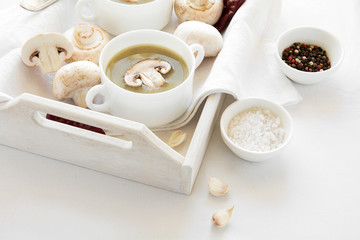 Two bowl with traditional mushroom soup cream on white table cloth