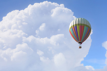 Aerostat floating in day sky. Mixed media