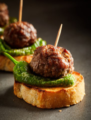 Roasted meatballs with pepper on baked bread
