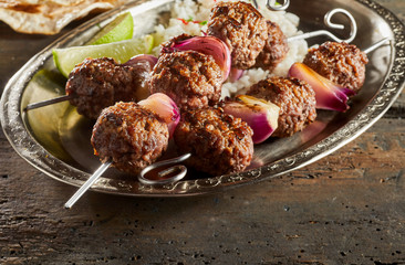 Baked kofta served with rice on metal plate