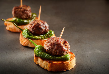 Meatball or frikadelle canapes on toasted baguette - obrazy, fototapety, plakaty