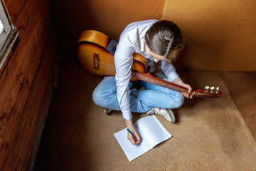 girl with a guitar who writes a song