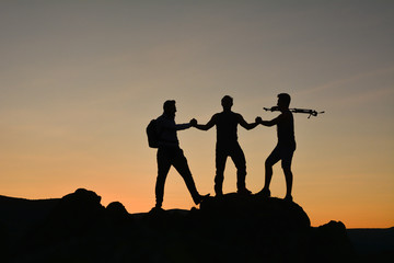 Fototapeta premium sunrise and team success in the mountains