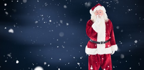 Composite image of santa asking for quiet to camera