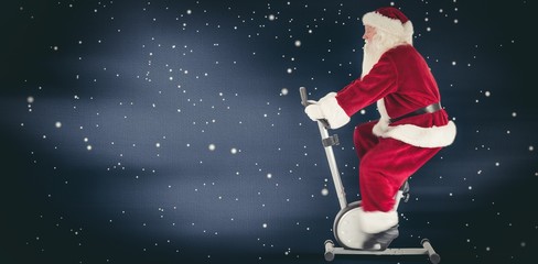 Composite image of santa uses a home trainer