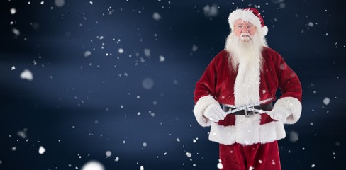 Composite image of santa claus measures his belly