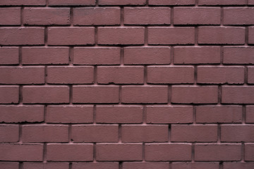 Brick wall made of red stone background. The spoiled brick is vintage.