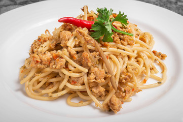 Spicy pork spaghetti on a white plate