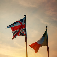 Italian and British flag on a pole in sunset
