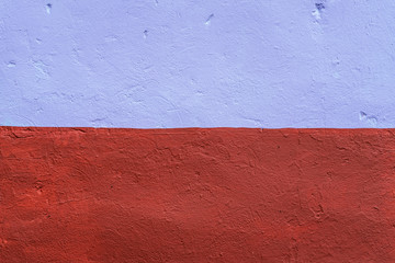 The homogeneous background of the wall is dyed with a brown and purple paint. In the city in the fresh air. The background of the concrete fence.