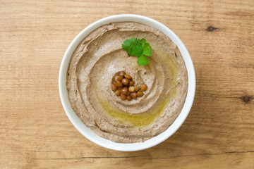 Lentil hummus in bowl on wood