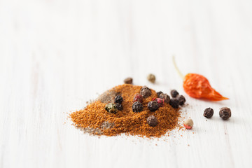 Red, black pepper and bell pepper, dry chilli pod on white wooden table