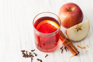 A glass of mulled wine with chopped Apple and cinnamon