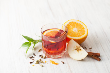 Mulled wine in glass with Apple, cinnamon and orange