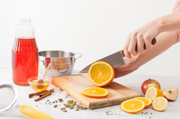 Cutting orange slices for mulled wine