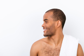Obraz premium Hygiene, vitality, beauty, men life concept. Side profile view of afro young nude guy with white towel on his shoulder, isolated on pure background