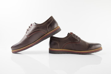 Male brown leather shoes on white background, isolated product, comfortable footwear.