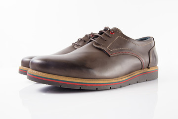 Male brown leather shoes on white background, isolated product, comfortable footwear.