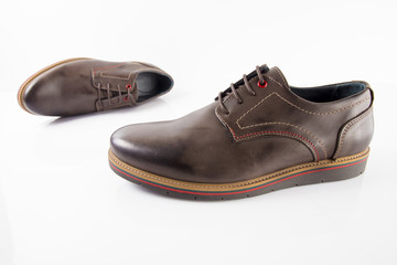 Male brown leather shoes on white background, isolated product, comfortable footwear.
