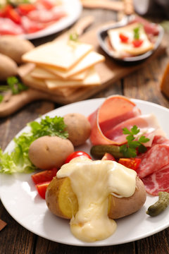 raclette cheese melted with potato and salami