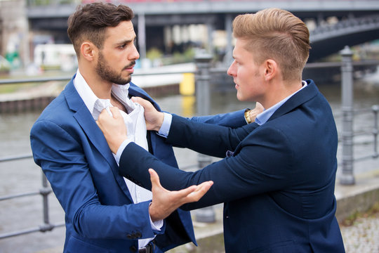 two businessmen having a fight outside