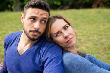 Obraz premium beautiful young couple sitting in park