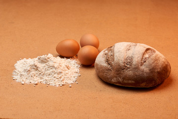 flour with three eggs and a loaf