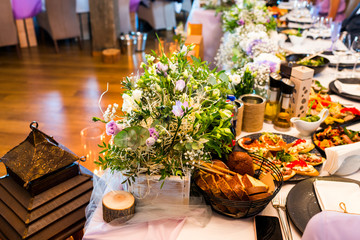 table with food and flowers at the banquet