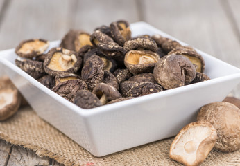Wooden table with Dried Shiitake, selective focus