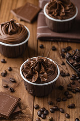 Homemade chocolate cupcakes on wooden background