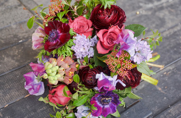 Beautiful designer red purple bouquet of florist with different flowers 