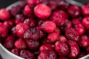Slate slab with Dried Cranberries (selective focus; close-up shot)