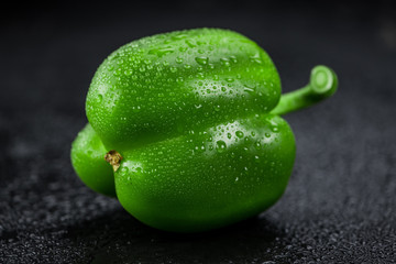 Fresh made Green paprika on a slate slab (close-up shot; selective focus)