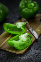 Fresh made Green paprika on a slate slab (close-up shot; selective focus)