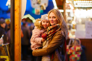 Mother and little daughter on Christmas market