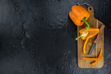 Some fresh made  Orange paprika on a vintage slate slab (selective focus)