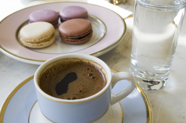 Turkish coffee and macaroons on table in cafe restaurant