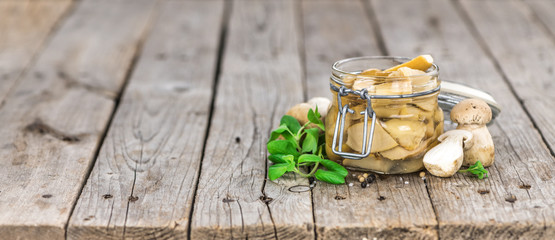 Preserved Porcinis on vintage wooden background