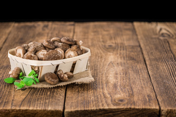 Wooden table with Shiitake mushrooms, selective focus