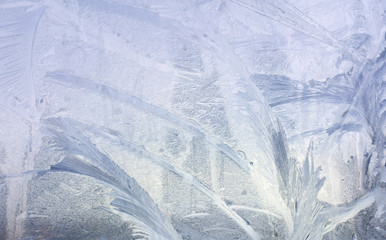 Ice patterns on winter glass. Christmas frozen background. Winter toning effect.