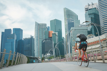 man take exercise by bicycle in singapore city