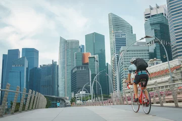 Poster man take exercise by bicycle in singapore city © photostriker