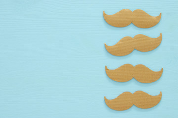 Movember cancer awareness event concept over wooden background. Top view